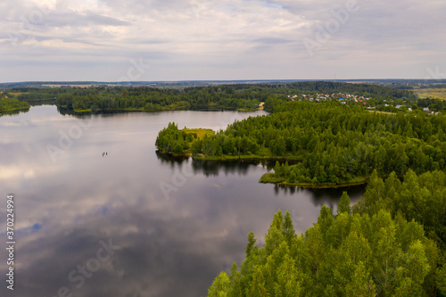 Fototapeta Naklejka Na Ścianę i Meble -  panoramic landscape of lake and forest around in summer at dawn filmed from a drone