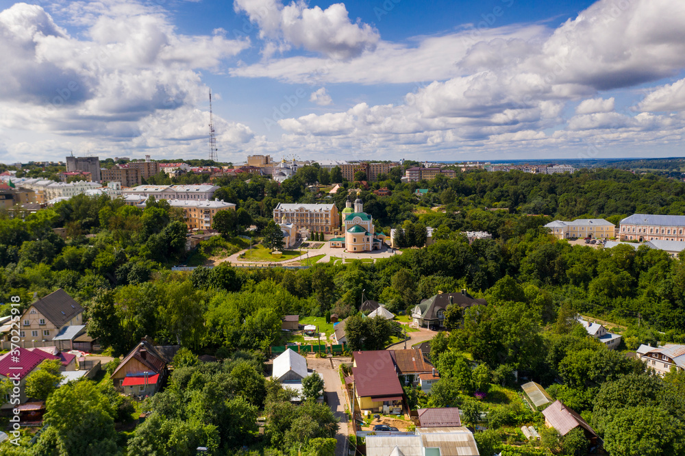city panoramic landscape in summer with a temple on a hill filmed from a drone