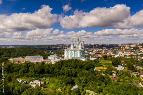 city panoramic landscape in summer with a temple on a hill filmed from a drone © константин константи