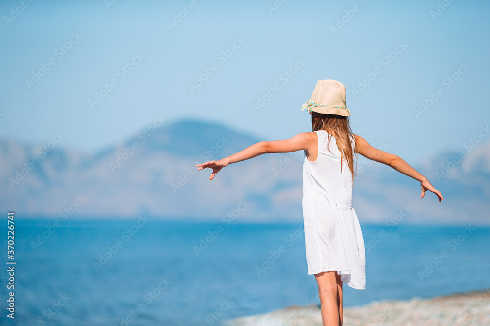 Cute little girl at beach during summer vacation Cute little girl at beach during summer vacation