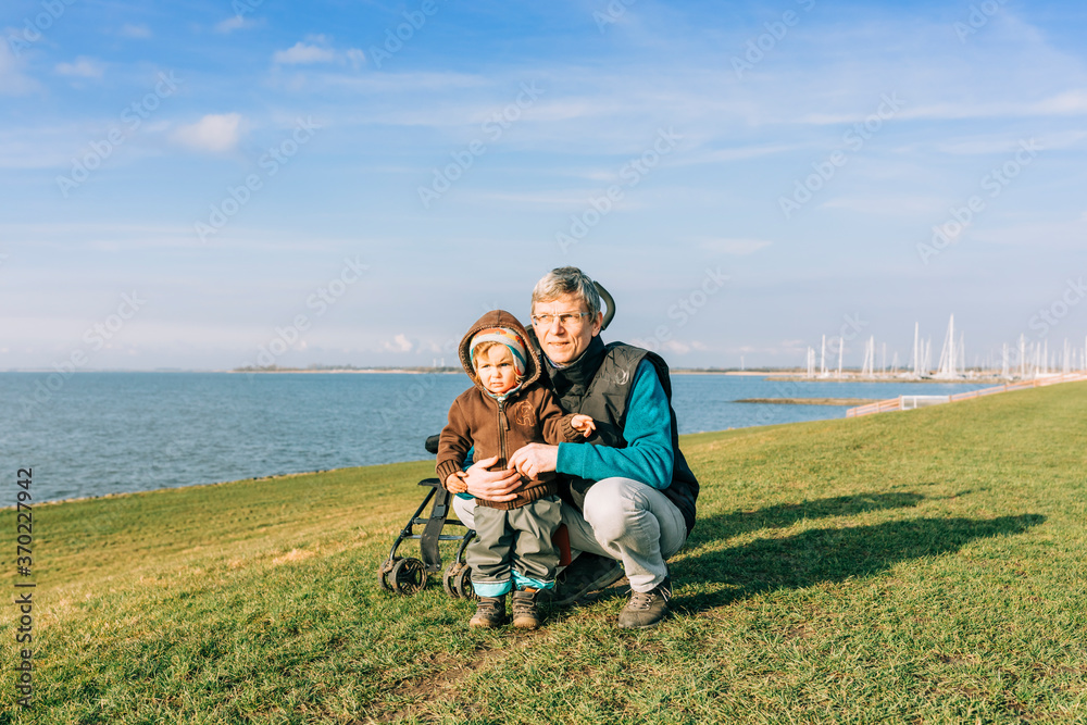 Man with toddler girl on dyke of IJsselmeer Man with toddler girl on dyke of IJsselmeer
