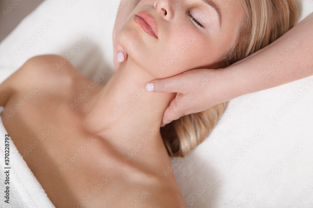 Cropped close up of a professional masseuse massaging neck of a beautiful woman Cropped close up of a professional masseuse massaging neck of a beautiful woman
