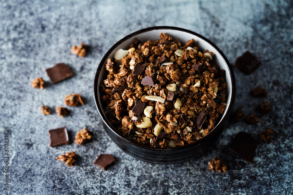 Chocolate nuts oatmeal granola with chocolate slices in a bowl Chocolate nuts oatmeal granola with chocolate slices in a bowl