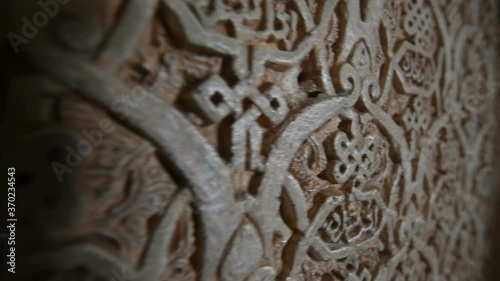 Close up dolly shot of ancient arabic writing carving at the Alhambra