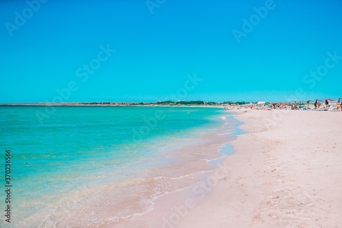 Idyllic tropical beach with white sand, turquoise ocean water and beautiful colorful sky © travnikovstudio