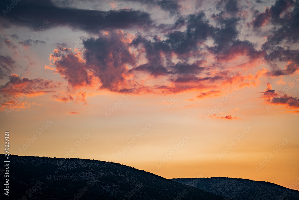 Wonderful landscape in mountains at sunset. Dramatic sky with colorful clouds over the hills. Beautiful natural landscape in the summer time.