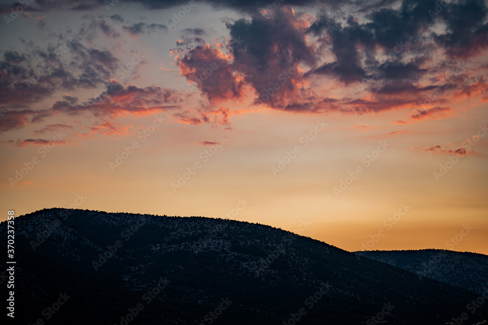Wonderful landscape in mountains at sunset. Dramatic sky with colorful clouds over the hills. Beautiful natural landscape in the summer time.