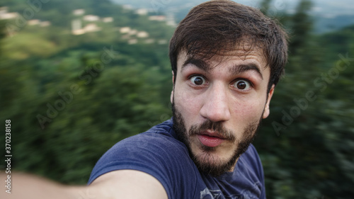 Young influencer or vlogger handsome man shooting vlog in nature close-up Life style concept