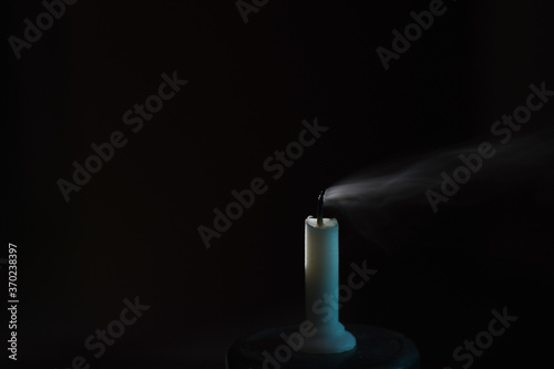 Blown candle on black background 