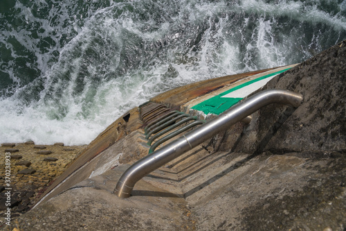 Ladder on the wall of a pier in Fecamp. photo