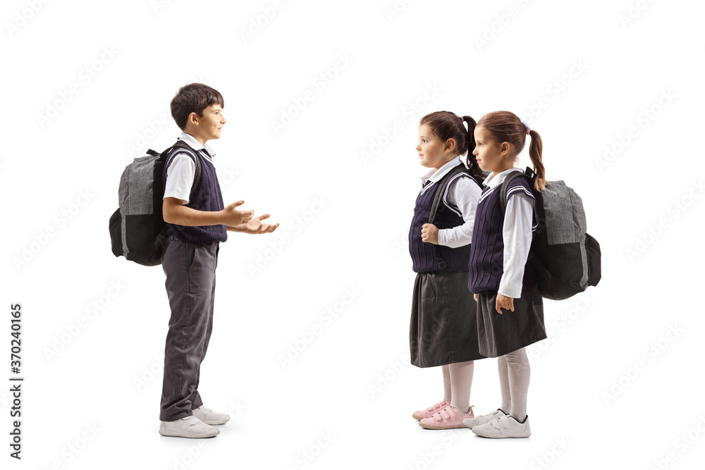 Full length profile shot of a schoolboy talking to schoolgirls in uniforms Full length profile shot of a schoolboy talking to schoolgirls in uniforms