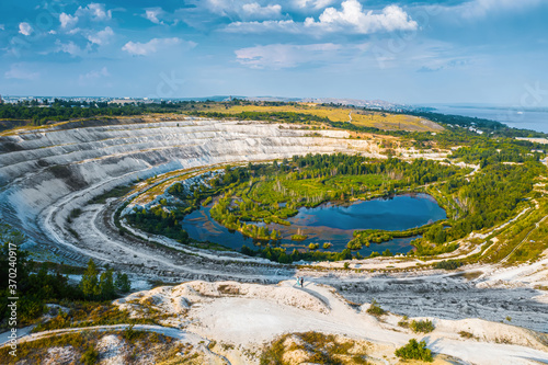 Old open-cast mine. Industrial extraction of chalk and by mining. Lake in quarry. Aerial. High quality photo