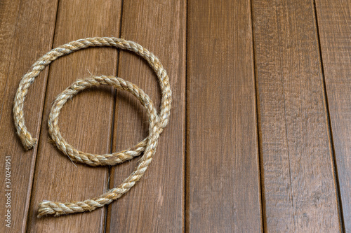 Natural hemp rope on wooden background. Natural product concept.