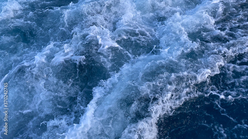 Fototapeta Naklejka Na Ścianę i Meble -  Seawater Ocean surface, sea foam on the blue ocean, background.