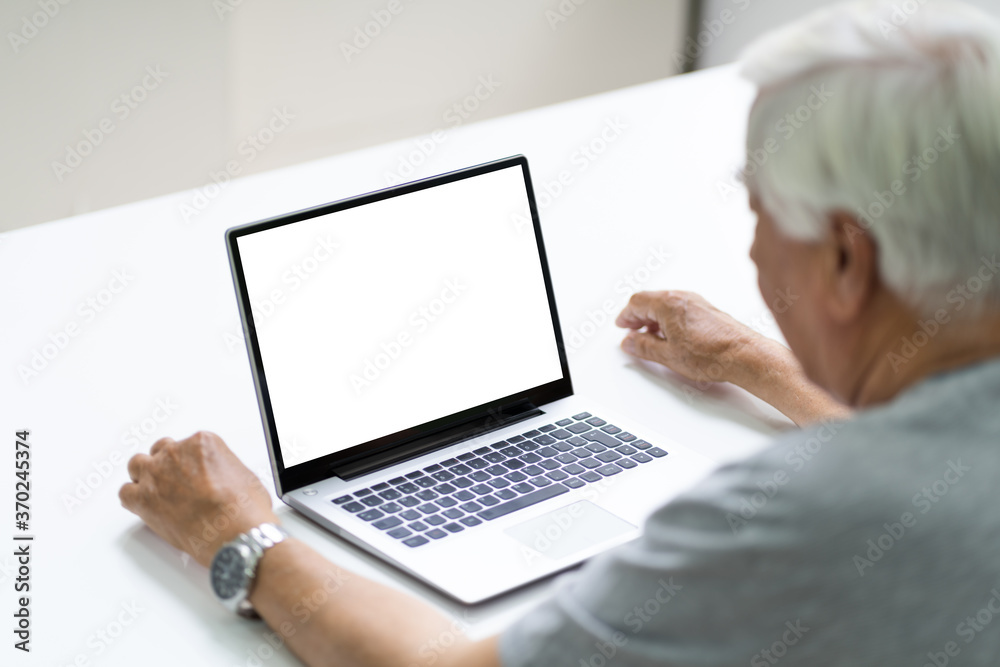Close-up Of Senior Man Using Laptop Showing Blank Screen