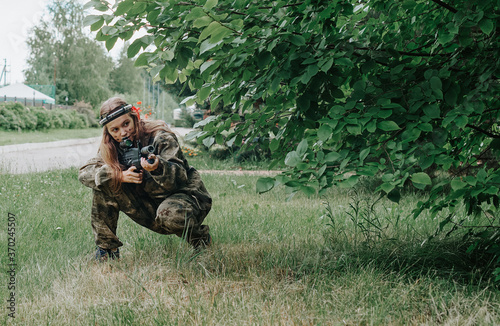 Girl playing in lasertag shooting game, girl with a gun, war simulation.