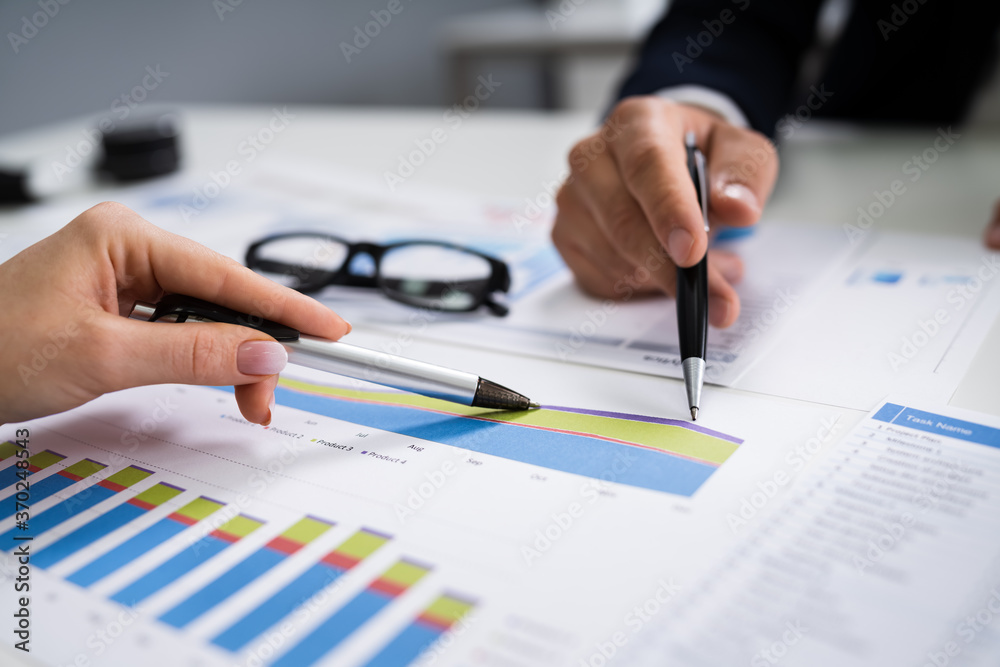 Financial Advisor Looking At Growth Progress Chart Financial Advisor Looking At Growth Progress Chart