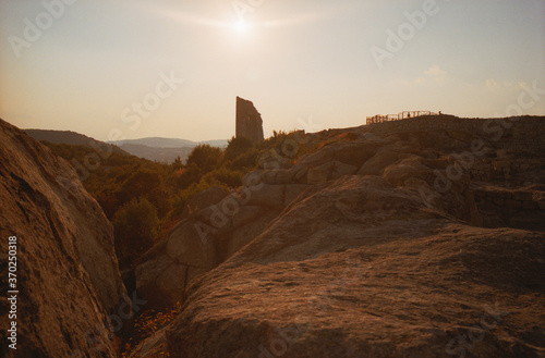 View of the ancient ruins of Perperikon in Bulgaria on a summer day at sunset. The real grain of the scanned film.