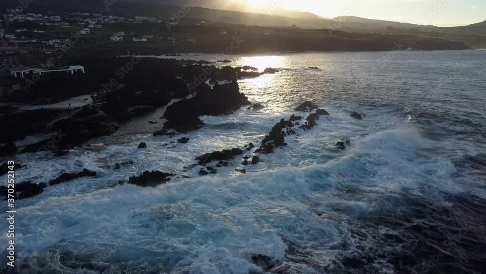 Aerial of Beautiful Blue Waves Rolling And Crashing Against Biscoitos Rocks