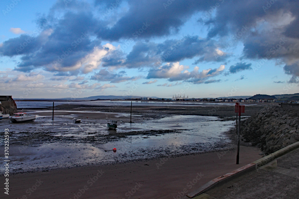 Boats in the harbour at Minehead in Somerset. The tide is out and the sky is stormy