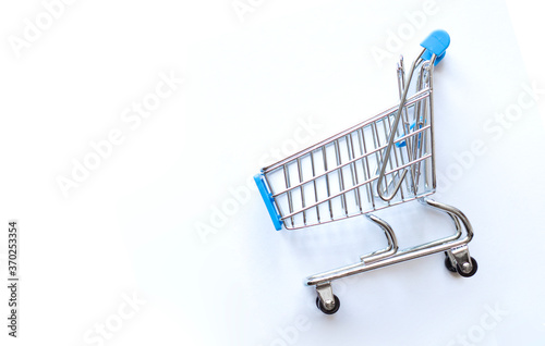 empty shopping cart on blue background, business concept
