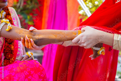 Indian pre wedding haldi ceremony ritual items, decorations and hands close up