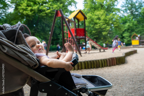 a small child on the playground in a pram