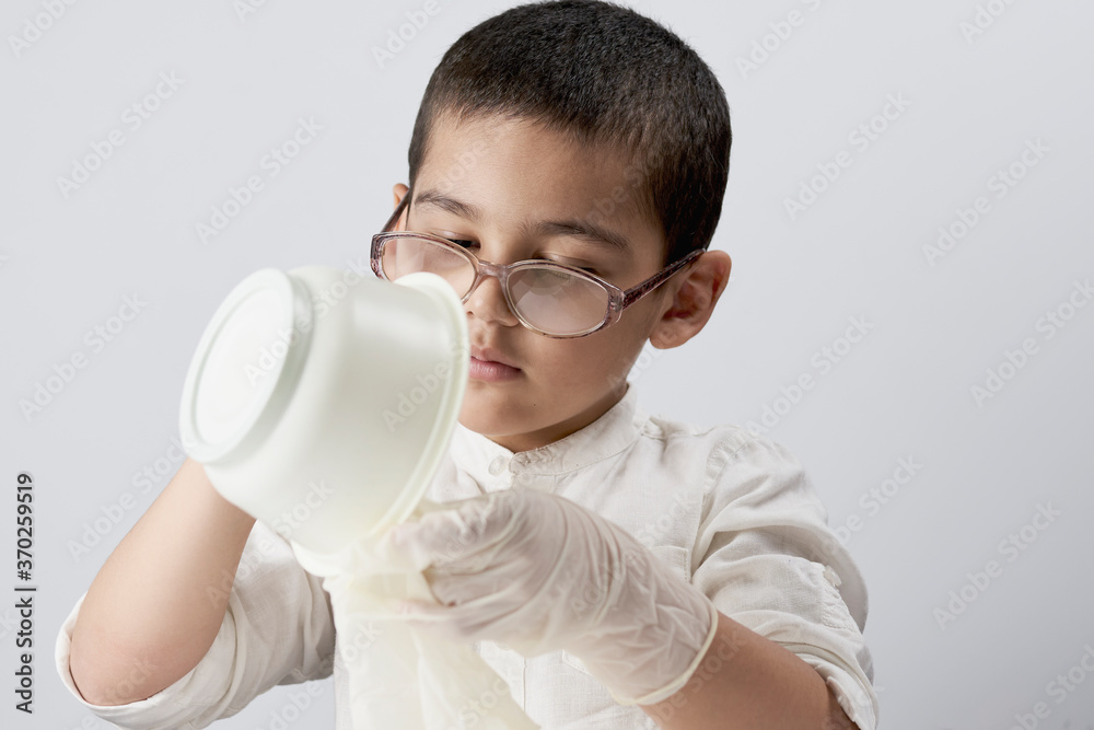 Portrait of a mixed race kid making experiments at home Portrait of a mixed race kid making experiments at home