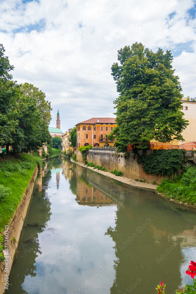 View of Retrone river and the clock tower of Vicenza, Italy