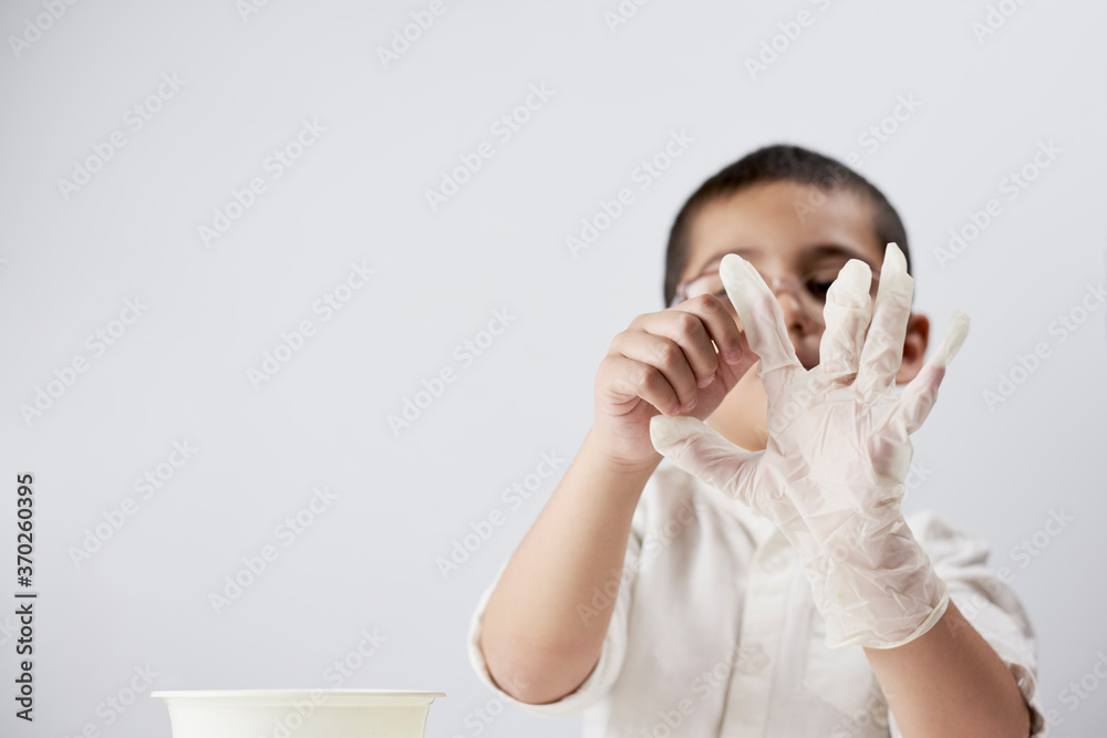 School boy wearing medical gloves to protect from virus School boy wearing medical gloves to protect from virus