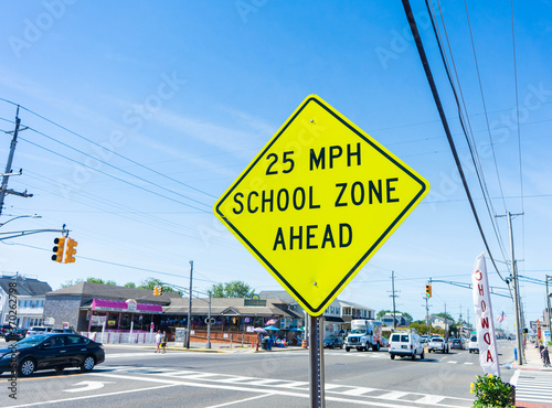Street sign that states '25 MPH SCHOOL ZONE AHEAD' to protect pedestrians and children in the school zone on Long Beach Island