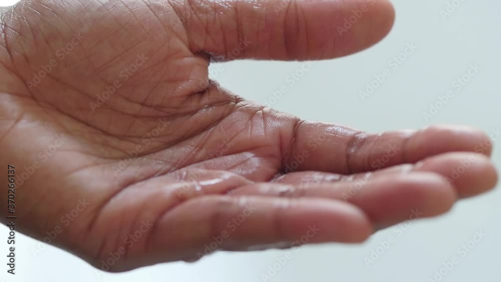 Close up of hands rubbing in sanitizer Close up of hands rubbing in sanitizer
