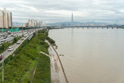 Seoul, Korea - August 8,2020: The Han River is rising beside Gangbyeon Expressway and some trees are submerged.