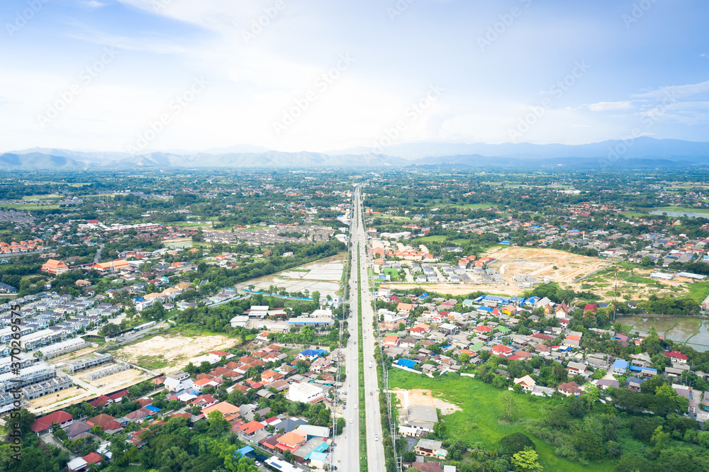 Fototapeta premium Aerial view of highway road of Chiang Mai-Lampang province of Thailand and vehicle on road.