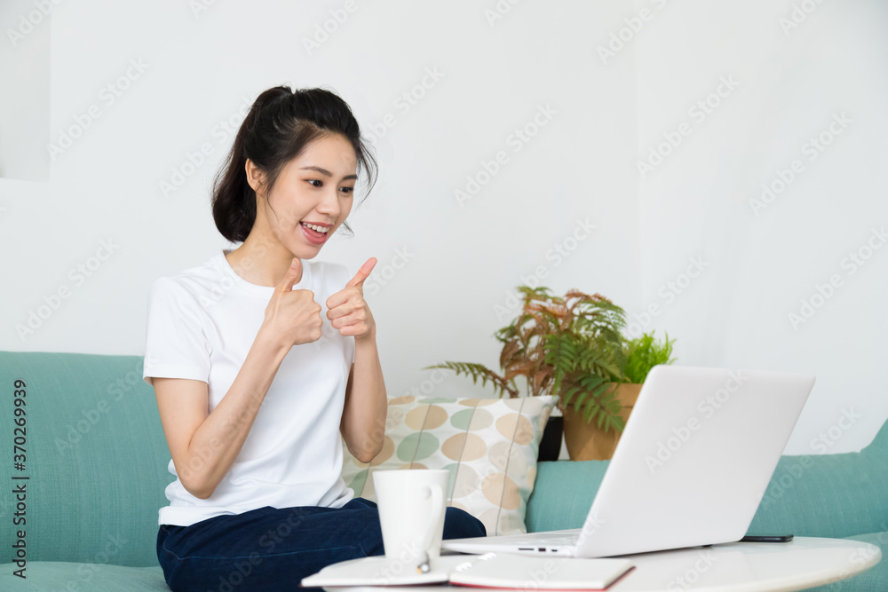 Beautiful freelancer female talking on video conference online with laptop at home. Study on online distant course. Talk on video call with friend or relative.