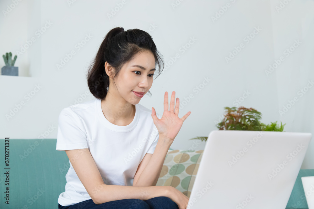 Beautiful freelancer female talking on video conference online with laptop at home. Study on online distant course. Talk on video call with friend or relative. Beautiful freelancer female talking on video conference online with laptop at home. Study on online distant course. Talk on video call with friend or relative.