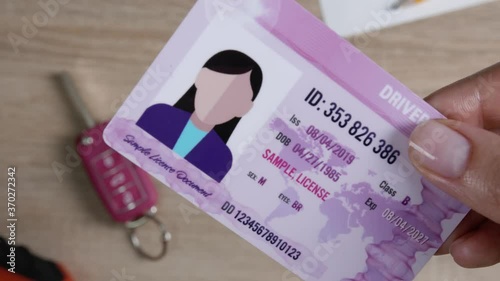 Woman showing driving license, closeup