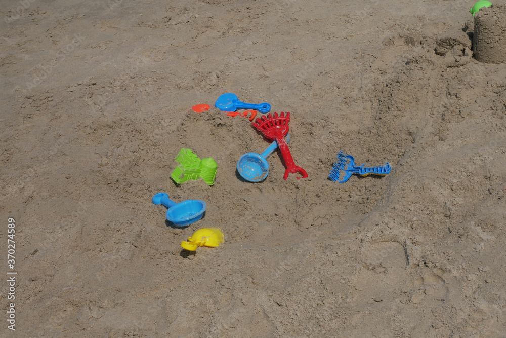 Some beach toys are made of plastic scattered randomly on the beach sand. Abandoned by children.
Some beach toys are made of plastic scattered randomly on the beach sand. Abandoned by children.