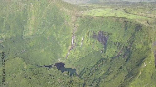 Aerial Pan shot of Giant Cascata Riberia Grande Waterfalls at Faj��zinha, Azores photo