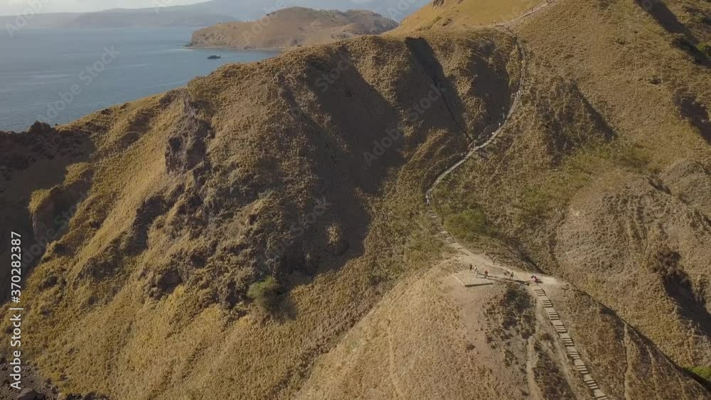 Aerial Fly Over Tourists Hiking Up Padar Island Mountain to Panorama Viewpoint Aerial Fly Over Tourists Hiking Up Padar Island Mountain to Panorama Viewpoint