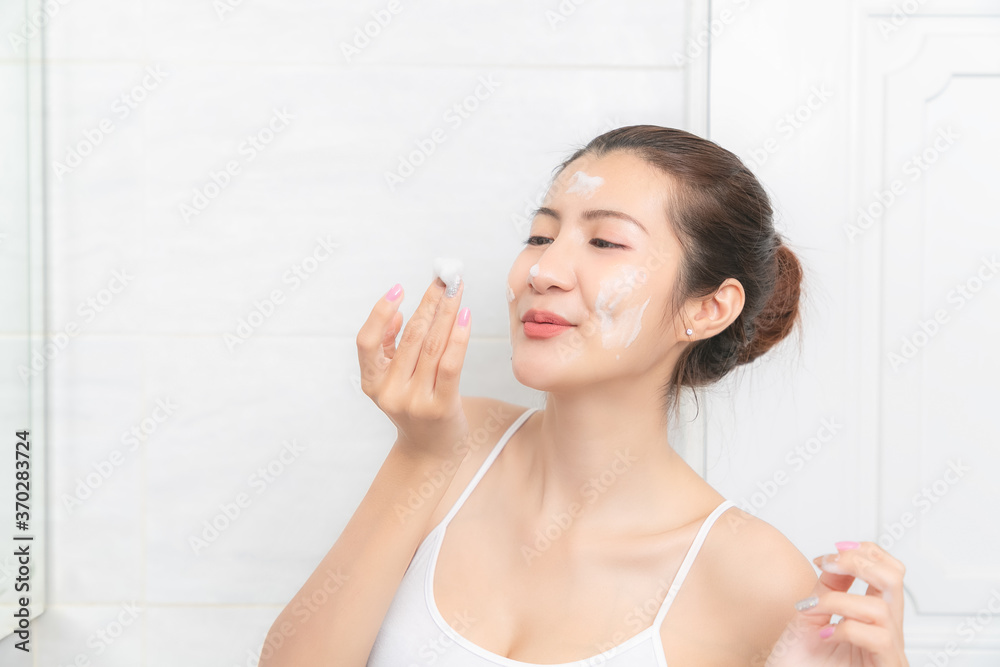 Happy young girl happy with cleansing mask on her face. Happy young girl happy with cleansing mask on her face.