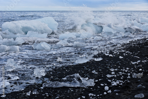 Glacial ice washed up on black sand beach at mouth of Jokulsa River, Jokulsarlon, southern Iceland