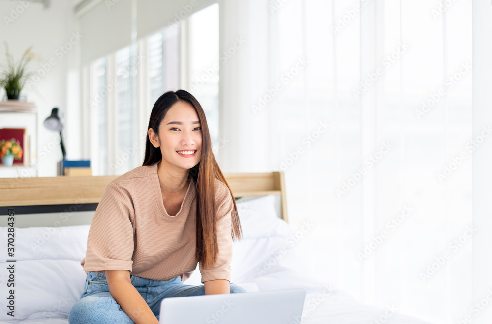 Asian woman working on laptop at home,Happy and smiling,Working from home Asian woman working on laptop at home,Happy and smiling,Working from home