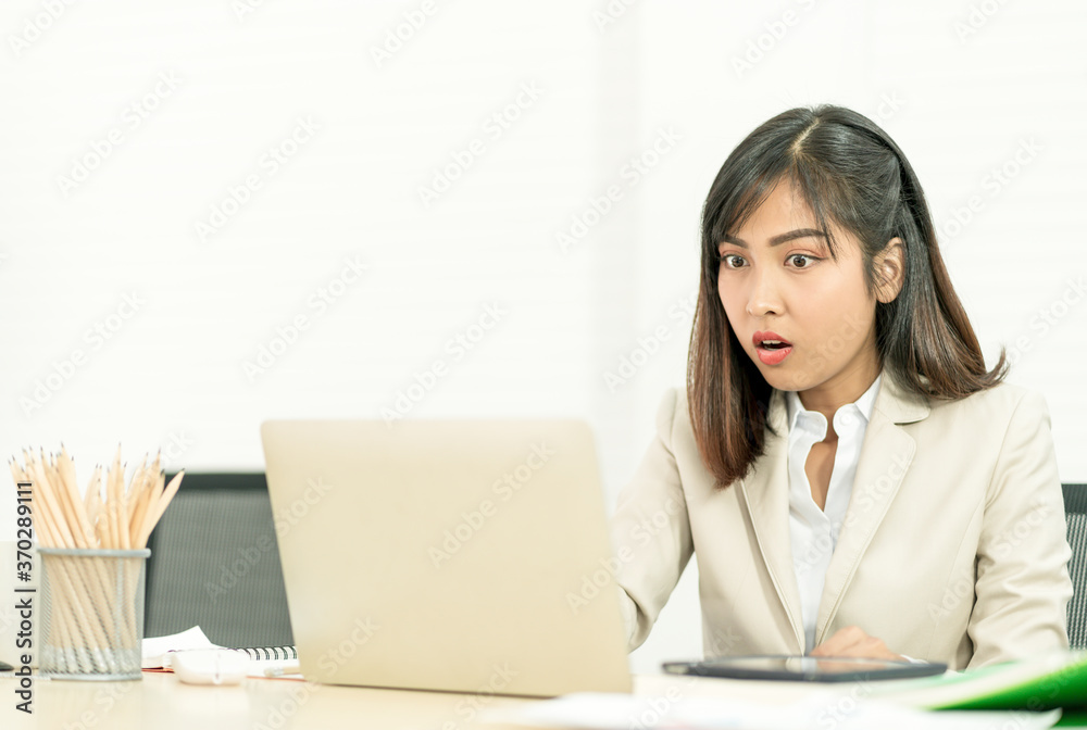 Asian business woman working at her office via laptop. Young female manager using computer at workplace Asian business woman working at her office via laptop. Young female manager using computer at workplace