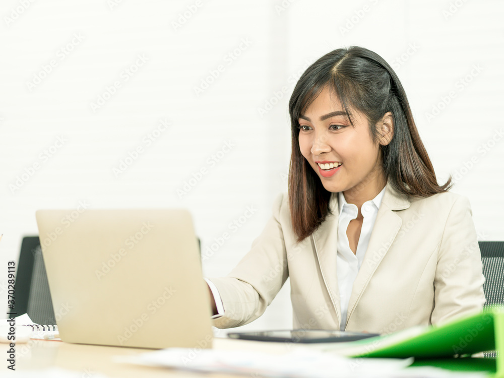 Asian business woman working at her office via laptop. Young female manager using computer at workplace Asian business woman working at her office via laptop. Young female manager using computer at workplace