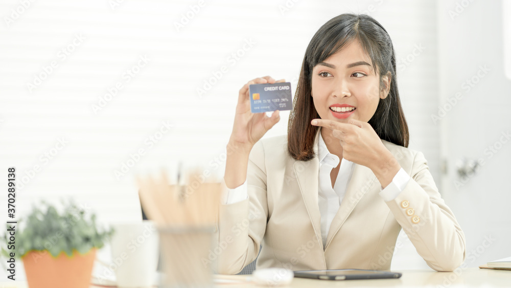 Asian woman holding credit card. Online Shopping, internet banking, spending money Concept Asian woman holding credit card. Online Shopping, internet banking, spending money Concept