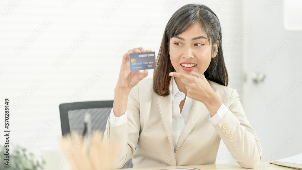 Asian woman holding credit card. Online Shopping, internet banking, spending money Concept Asian woman holding credit card. Online Shopping, internet banking, spending money Concept