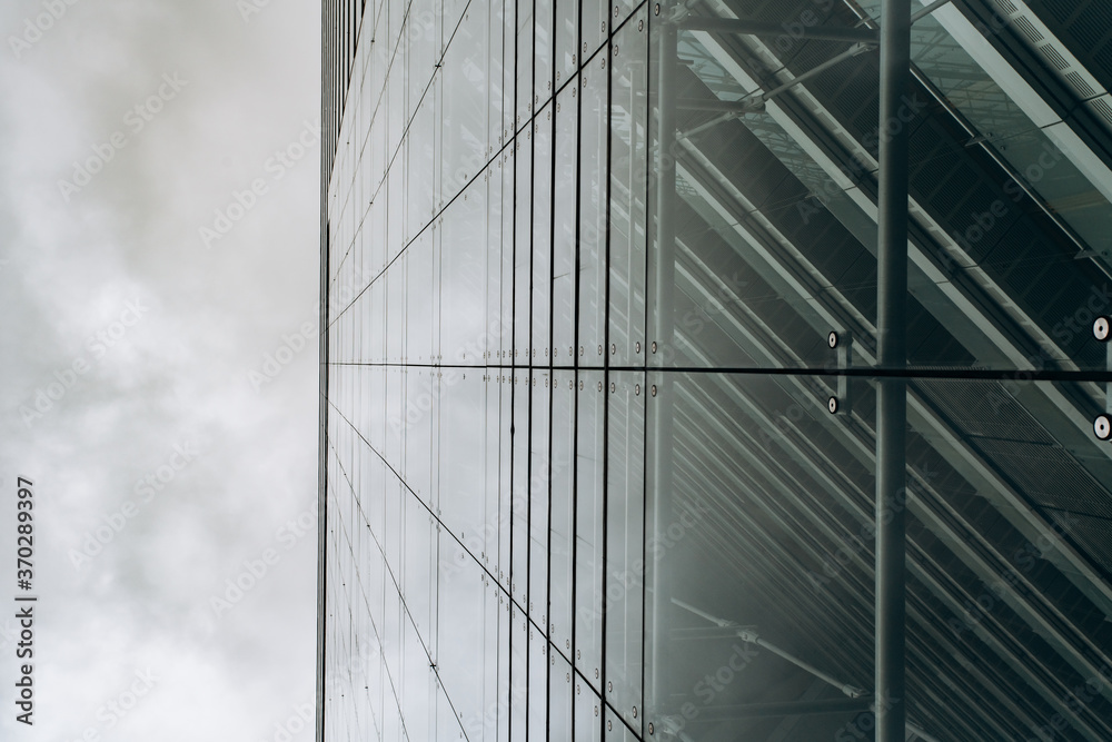 Dramatic view of skyscrapers against cloudy sky. View of the skyscraper from below Dramatic view of skyscrapers against cloudy sky. View of the skyscraper from below