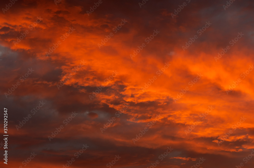 Cloudy landscape at sunset with a beautiful orange sky