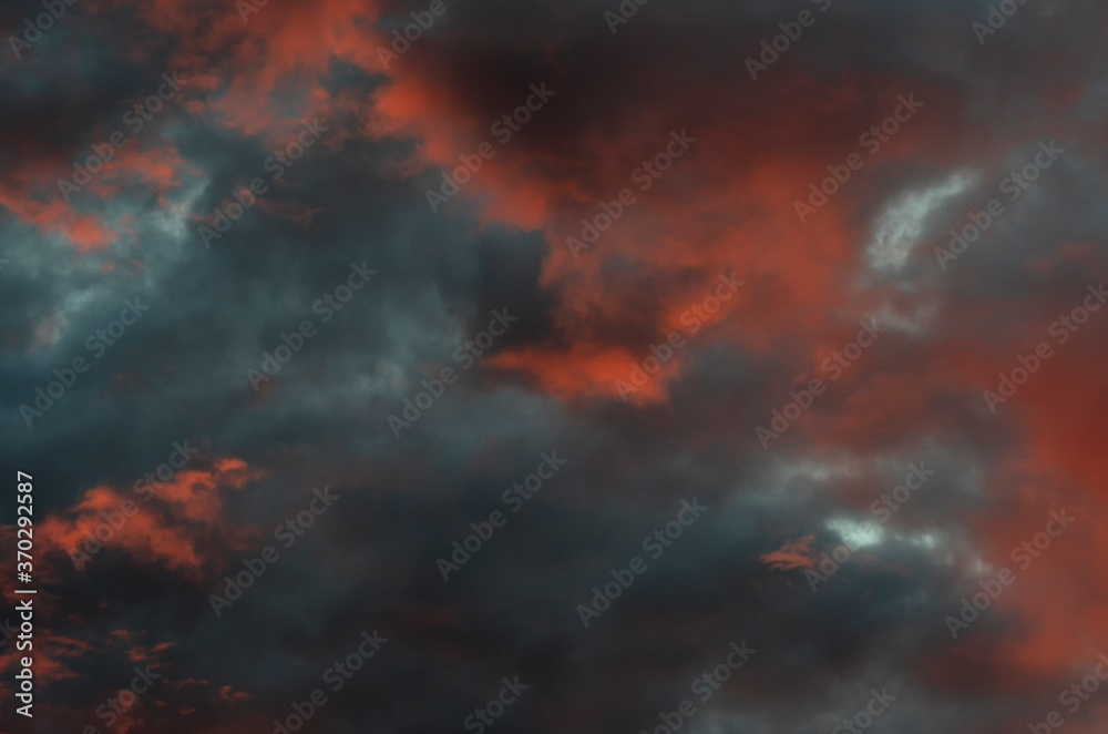 Dramatic blue-black sky framed by orange clouds at sunset